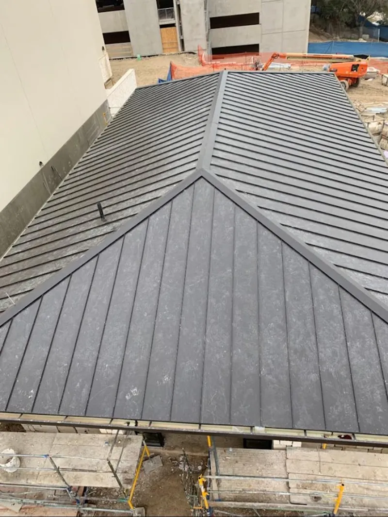 Commercial metal roof construction with crane equipment in Bradenton